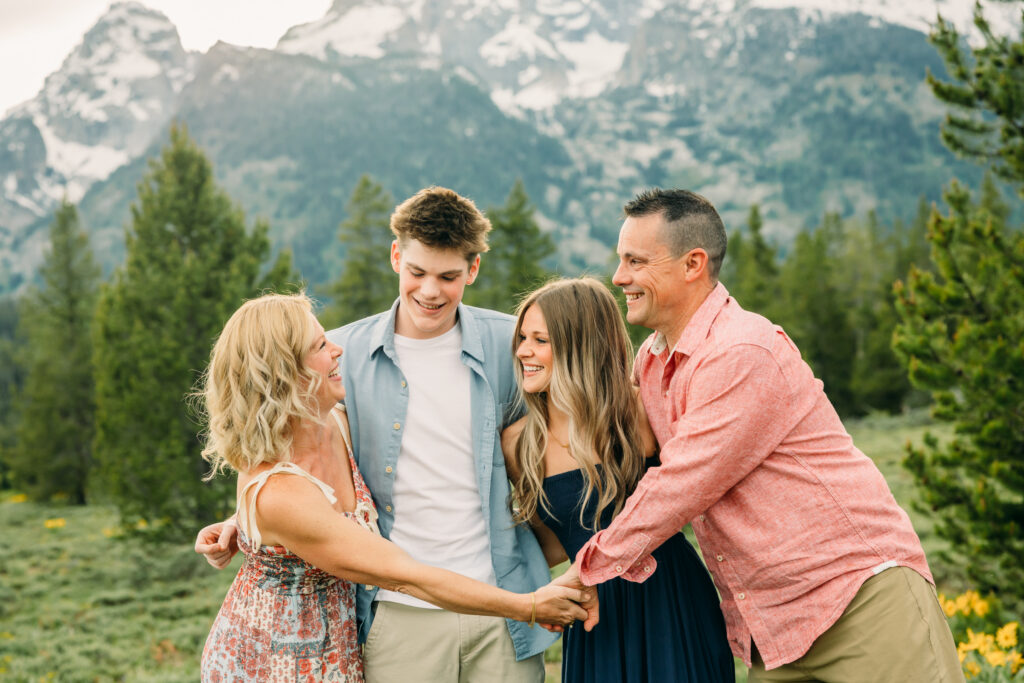 Sunset family photos with the Teton mountains in Grand Teton National Park in June with the sunflowers