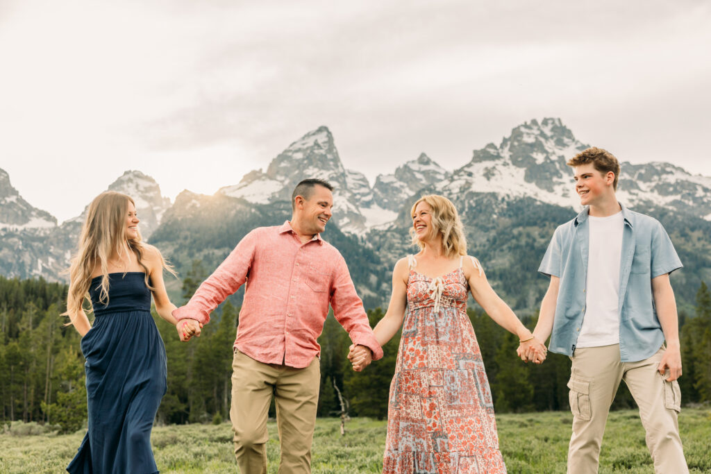 Sunset family photos with the Teton mountains in Grand Teton National Park in June with the sunflowers
