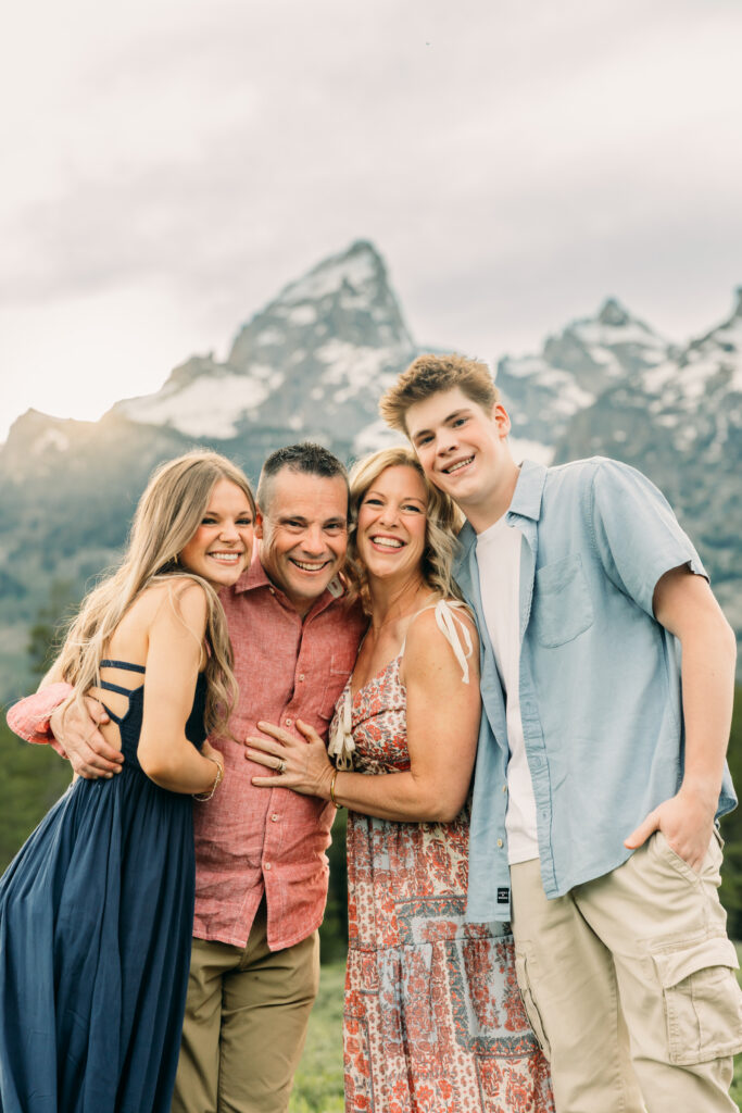 Sunset family photos with the Teton mountains in Grand Teton National Park in June with the sunflowers