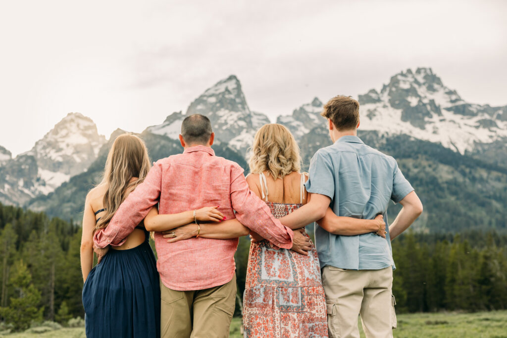 Sunset family photos with the Teton mountains in Grand Teton National Park in June with the sunflowers