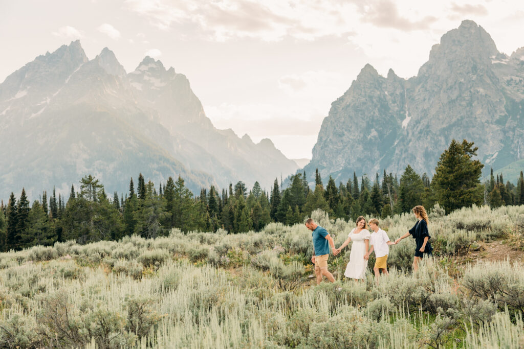 Mother and father hugging their kids during a mountain photo session in Grand Teton National Park Cascade Canyon Turnout