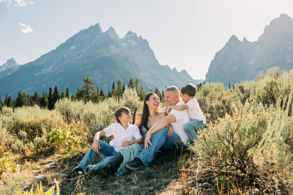 Jackson Hole family photographer afternoon session in the park with parents laughing together