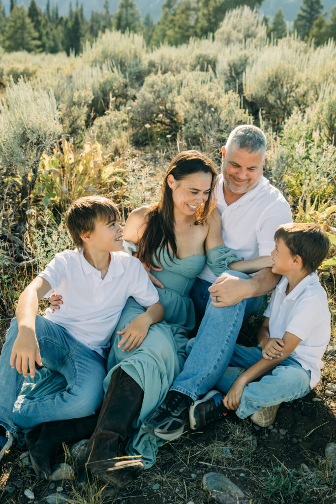 Jackson Hole family photographer afternoon session in the park with parents laughing together