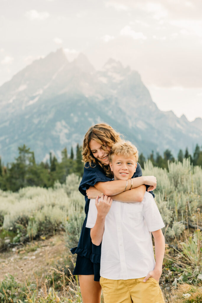 Kids running through grass during a Grand Teton family photography session