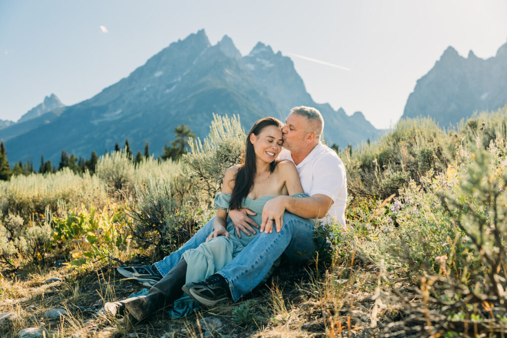 Jackson Hole family photographer afternoon session in the park with parents laughing together