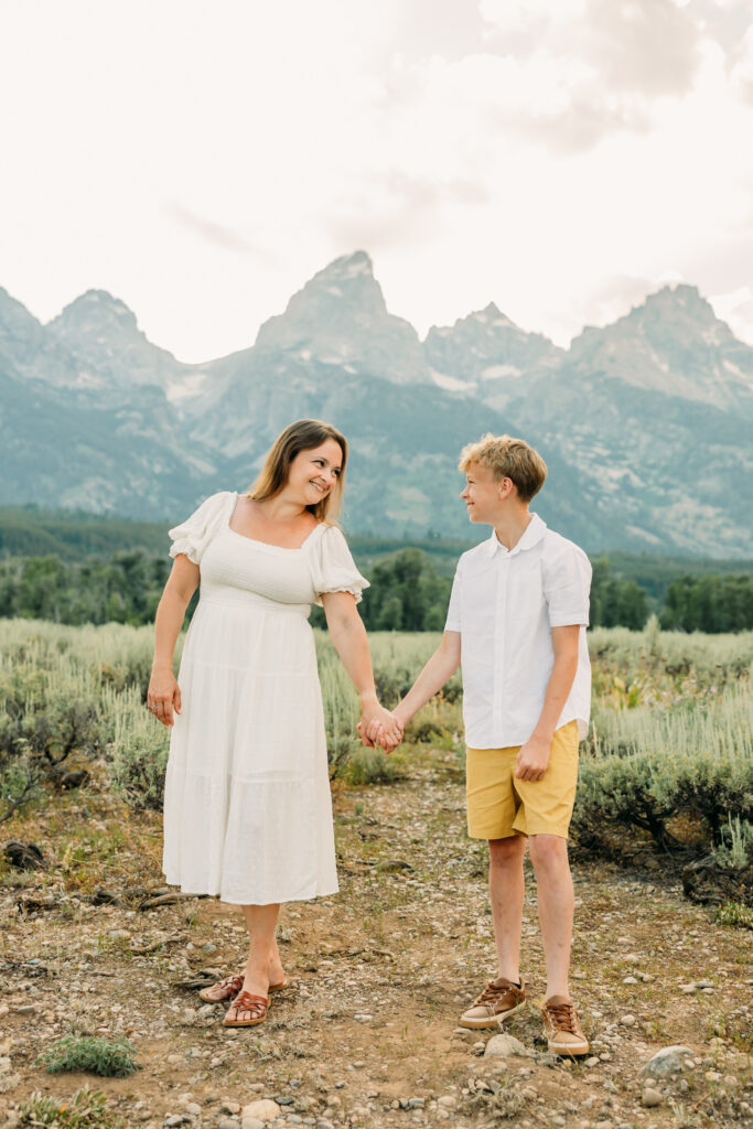 Family portraits with scenic Wyoming mountain backdrop at Cascade Canyon Turnout in Grand Teton National Park at sunset
