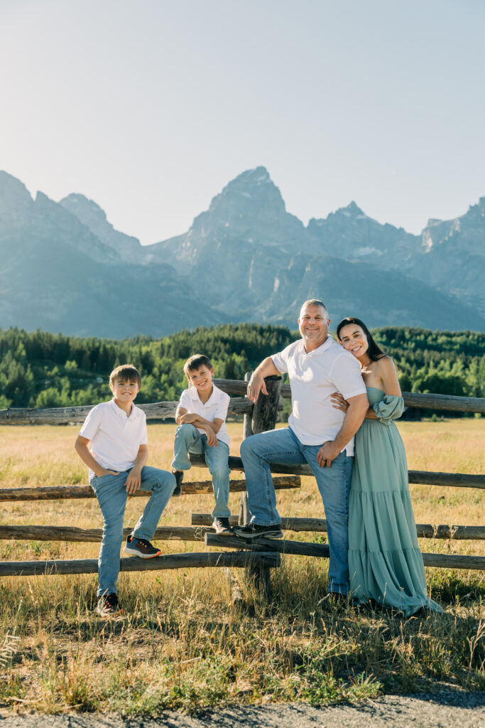 Jackson Hole family photographer afternoon session in the park with mountains in background and kids in meadow
