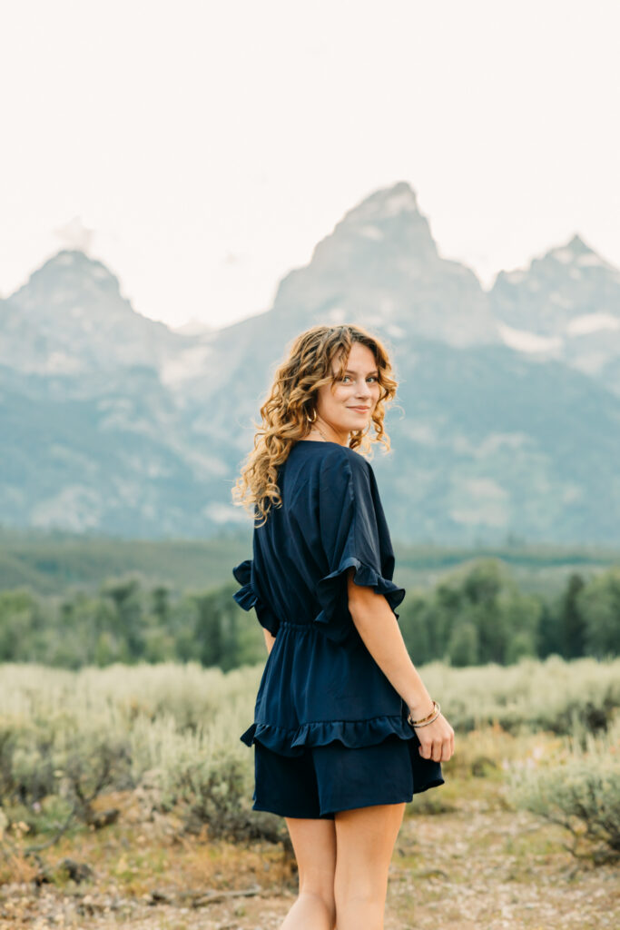 Family portraits with scenic Wyoming mountain backdrop at Cascade Canyon Turnout in Grand Teton National Park at sunset