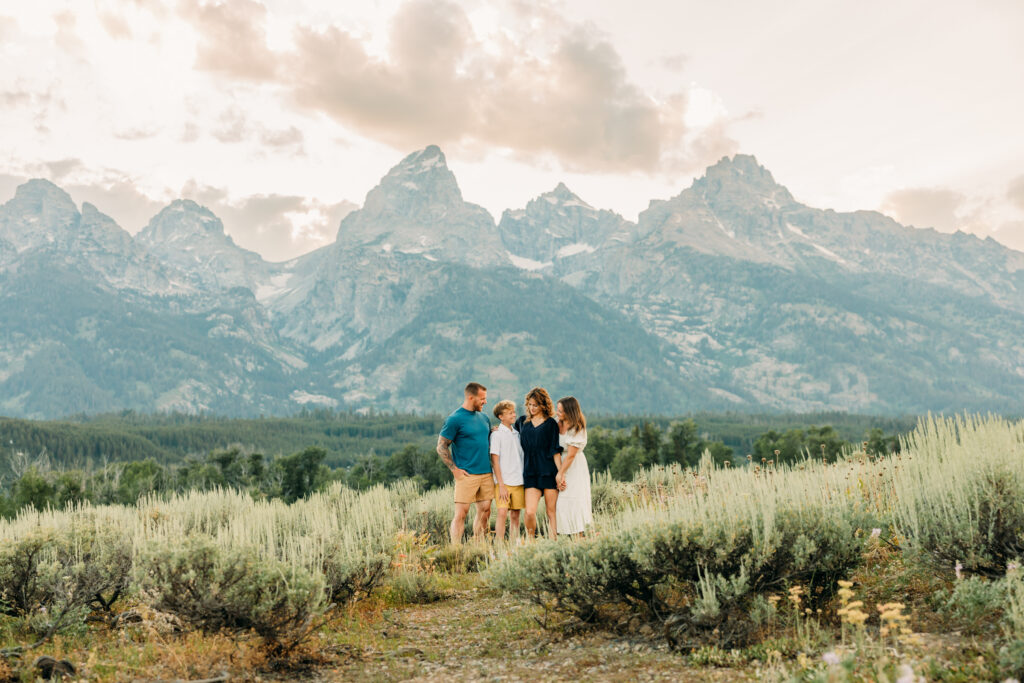 Family portraits with scenic Wyoming mountain backdrop at Cascade Canyon Turnout in Grand Teton National Park at sunset
