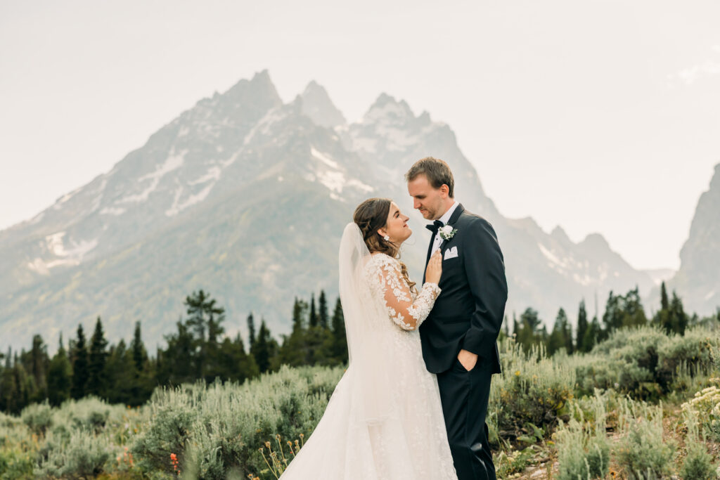 Best sunset location for photos in Grand Teton park for couples Cascade Canyon Turnout with sagebrush and laughing couple