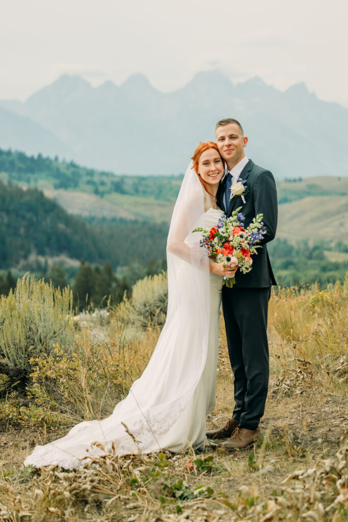 Adventure elopement photos with dramatic Teton mountains in Wyoming