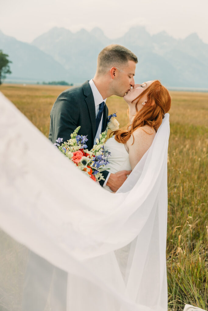 Bride and groom celebrating their Jackson Hole elopement with mountain views
