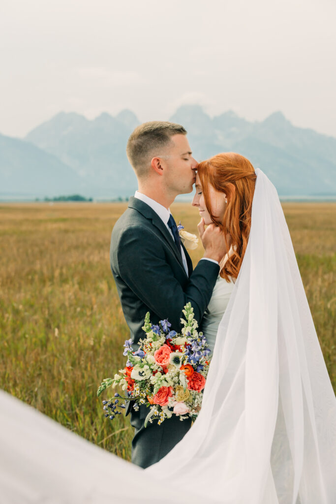Bride and groom celebrating their Jackson Hole elopement with mountain views