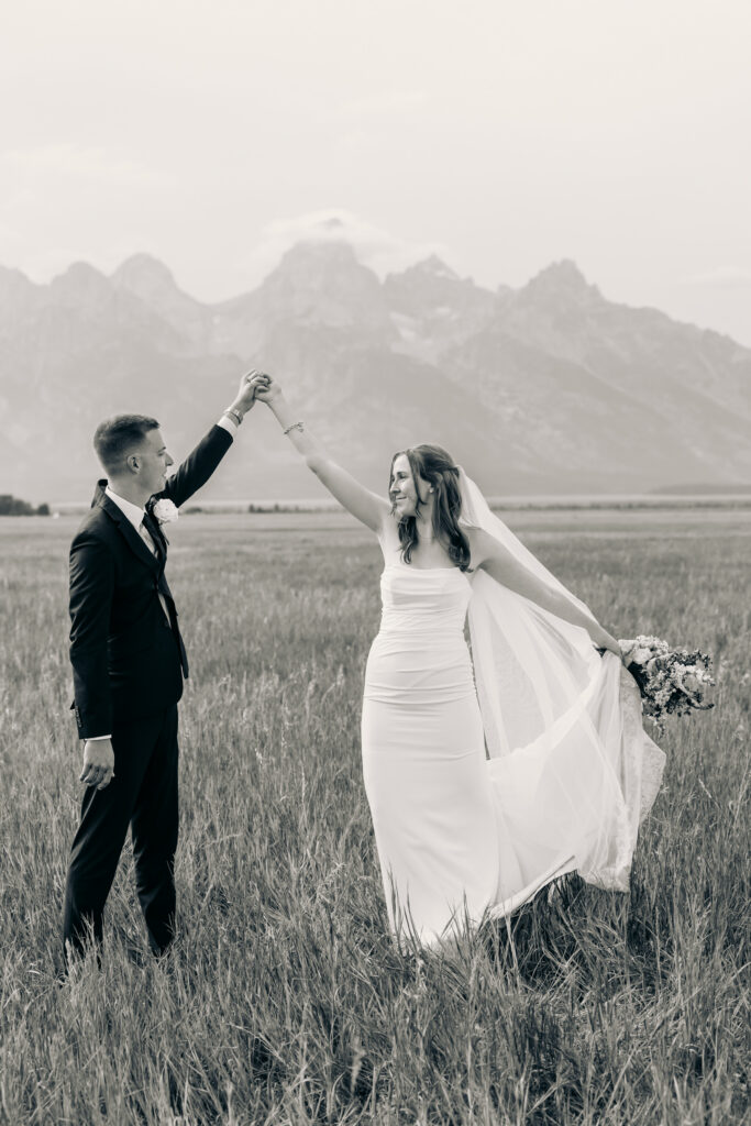 Bride and groom celebrating their Jackson Hole elopement with mountain views