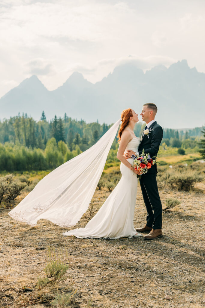 Eloping couple with the Teton mountain range in Grand Teton National Park