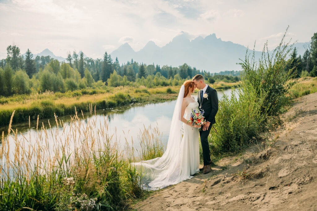Eloping couple with the Teton mountain range in Grand Teton National Park