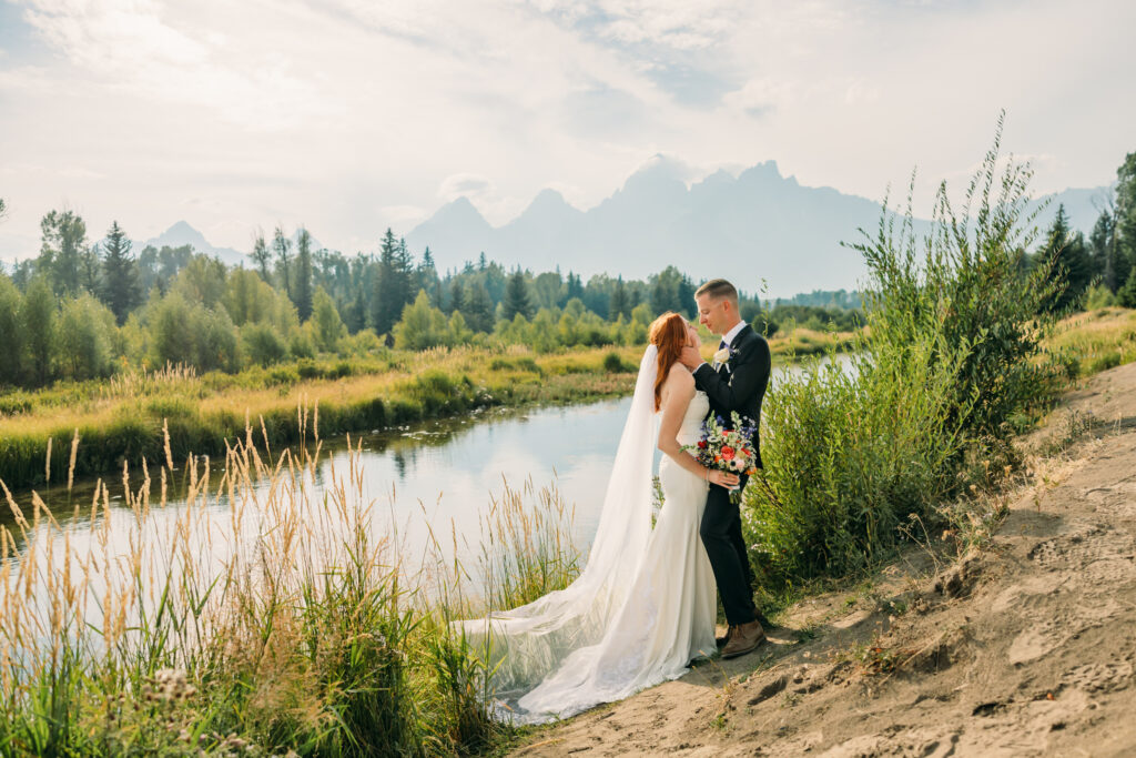 Eloping couple with the Teton mountain range in Grand Teton National Park